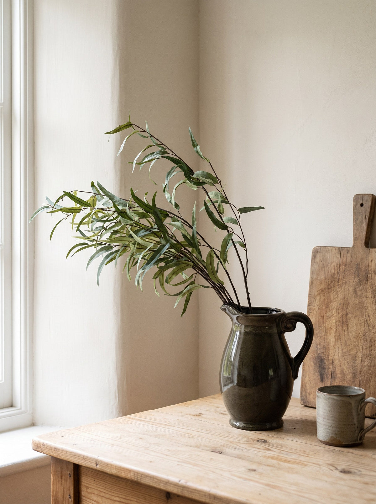 Faux eucalyptus in a reactive-glazed olive jug
