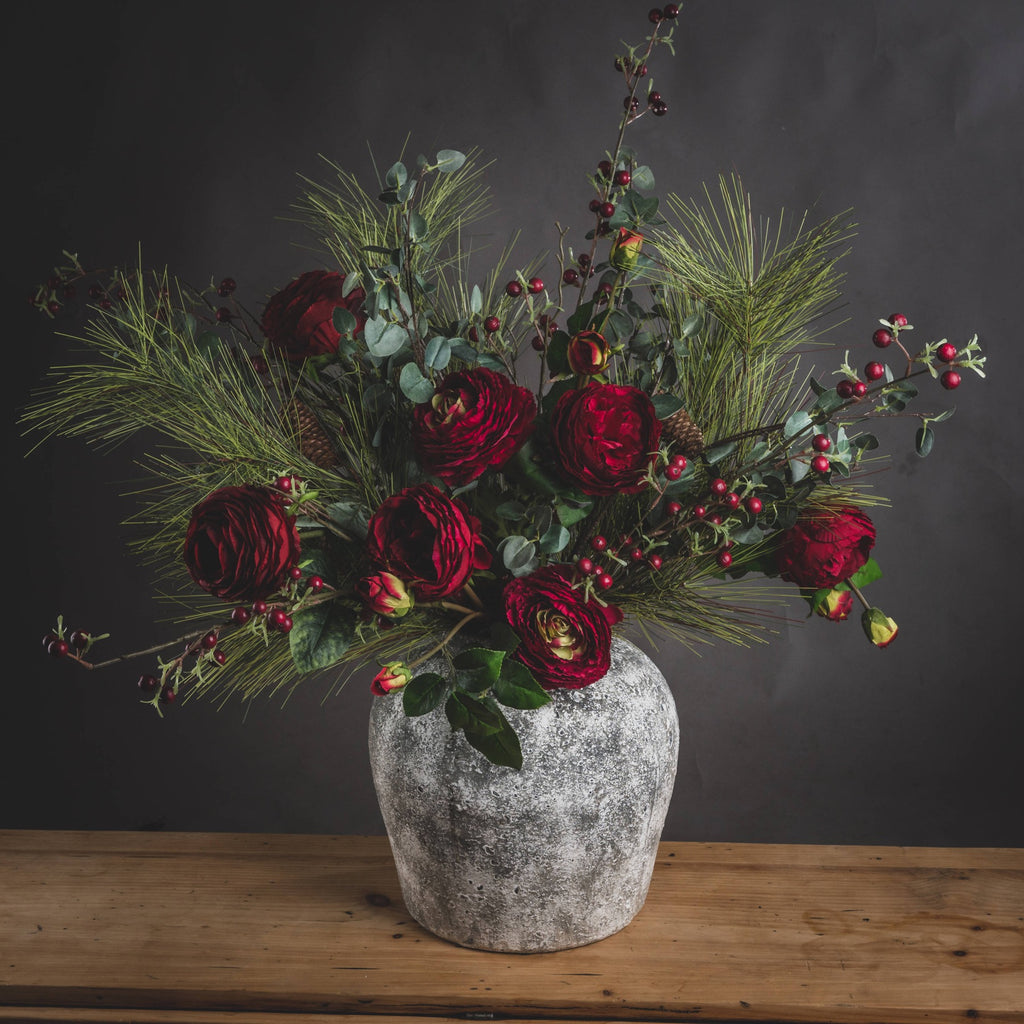 Cassis Aged Stone Vase with flowers on a wooden tabletop