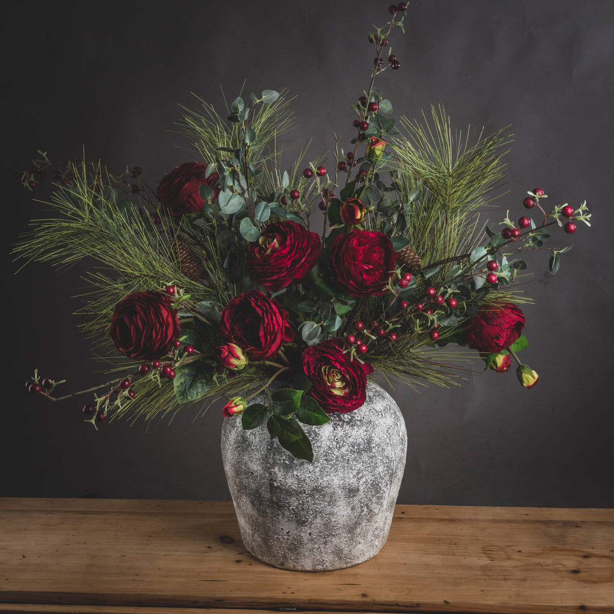 Cassis Aged Stone Vase with flowers on a wooden tabletop