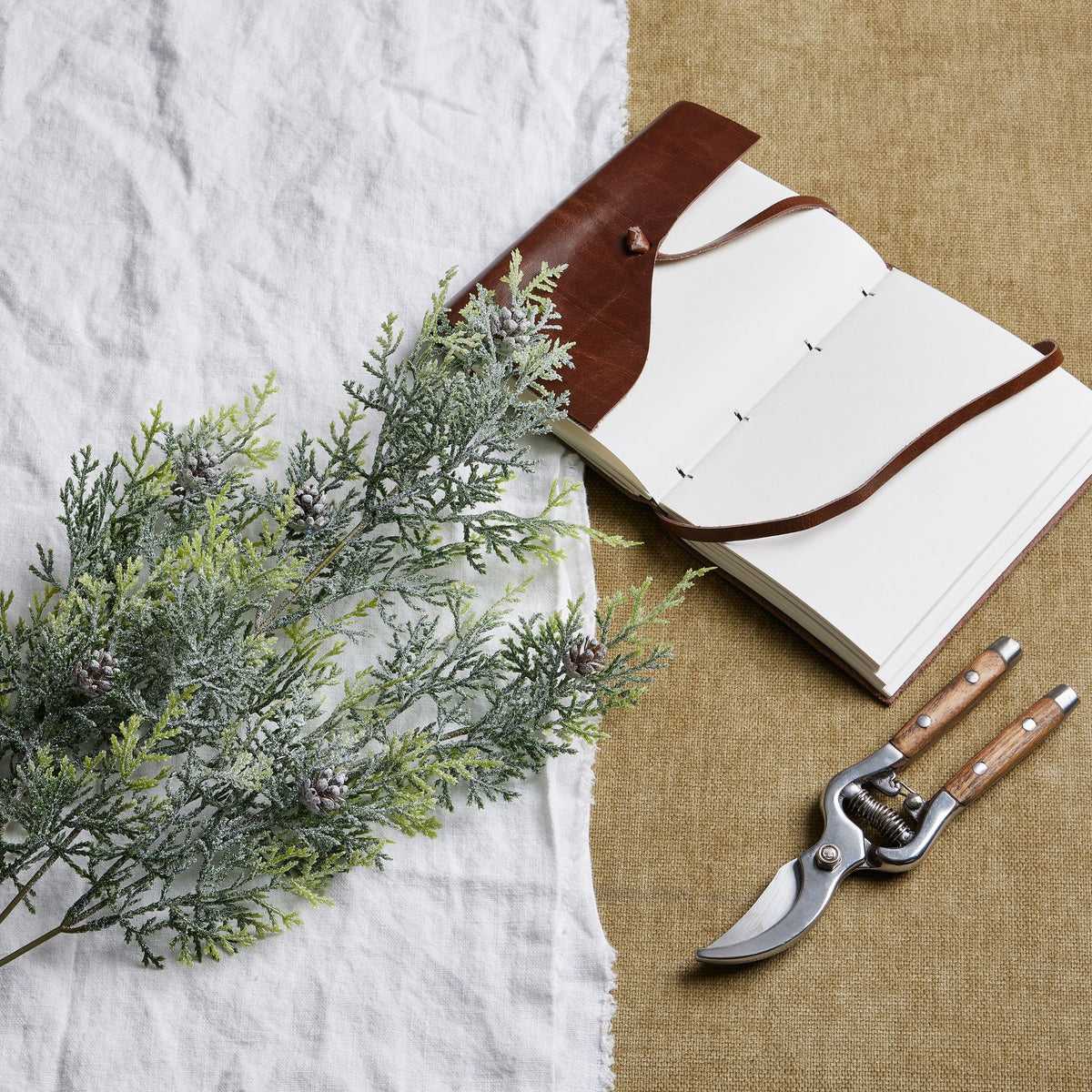 Artificial Frosted Pine Tall Stem with Pinecones, included in The Monte Winter White Arrangement