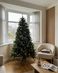 7ft pre-lit Forest Fir artificial Christmas tree in a bright bay window