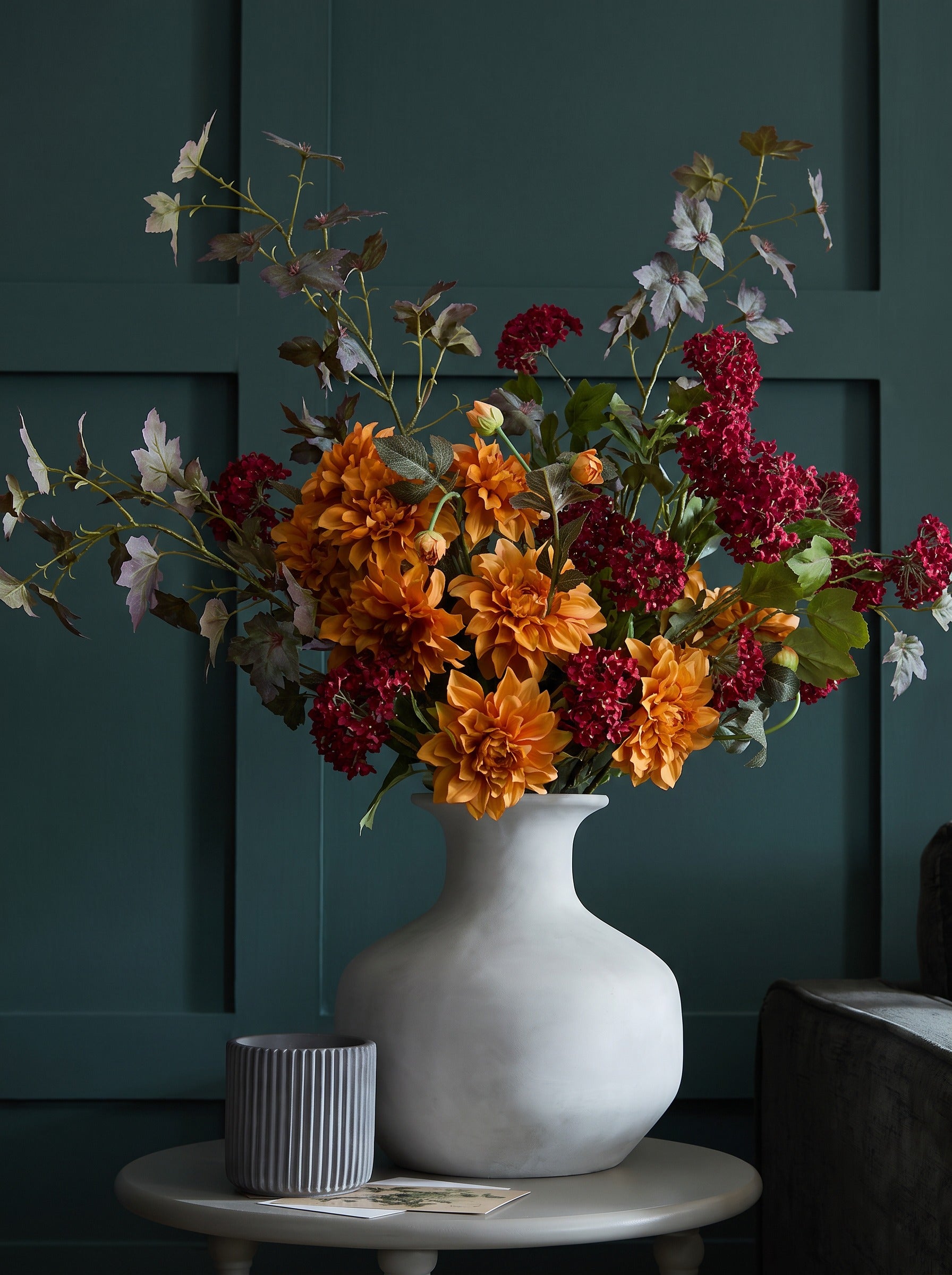 The Darcy Autumn Arrangement — orange dahlias, maple foliage and viburnum berries in the Darcy squat stone vase