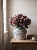 The Cassis Autumn Arrangement — aged stone vase with three burgundy hydrangea stems