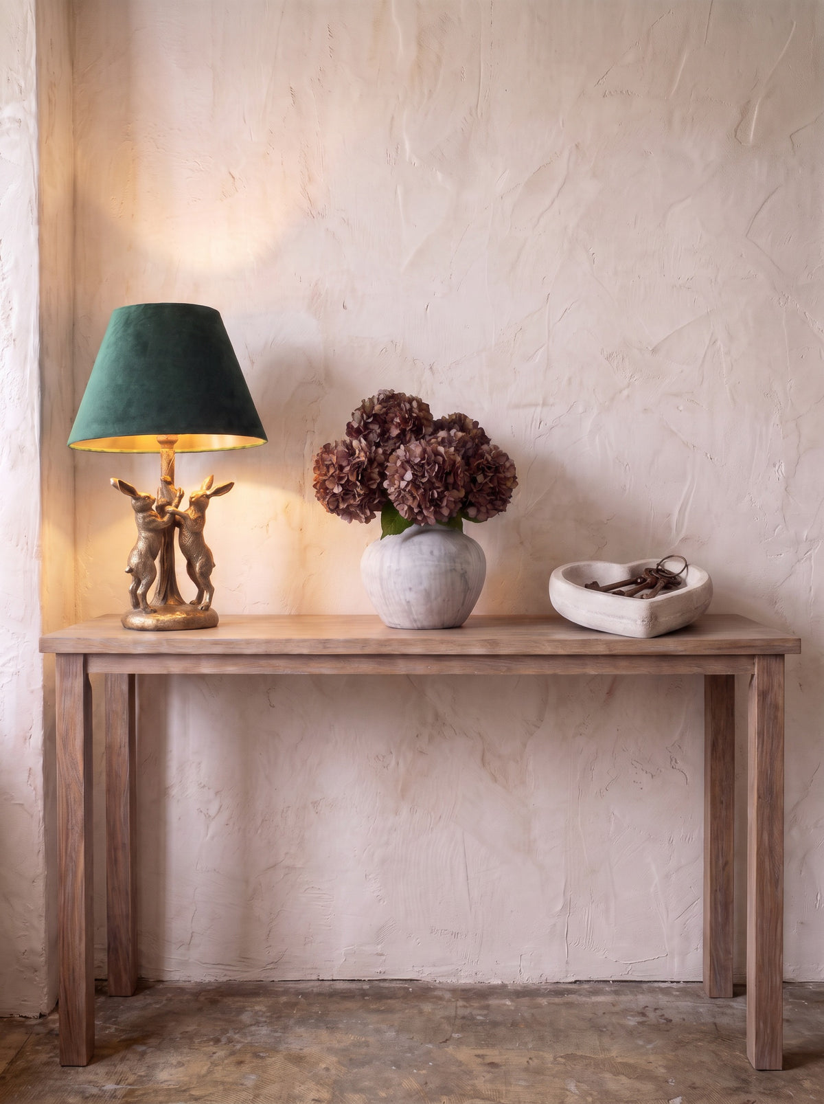 The Corner Edit — hares lamp, hydrangea vase and Coeur heart dish evenly spaced on a full console table