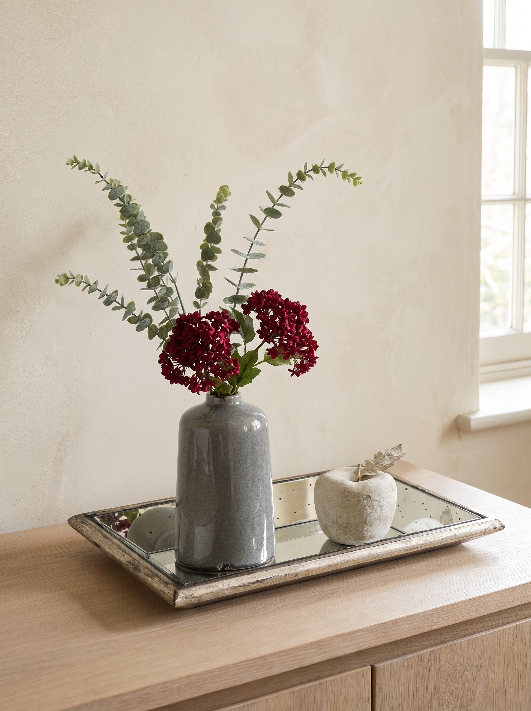 The Liv Tray Set — mirrored tray, crackle vase with eucalyptus and viburnum berries, and the Stone Apple