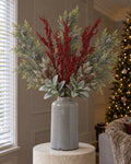 The Frosted Pine & Berry Christmas Bouquet in the grey Garda Liv vase from the With vase option: artificial frosted pine, red berry sprays, frosted cypress fir and lambs ear, on a stone plinth in a Christmas living room