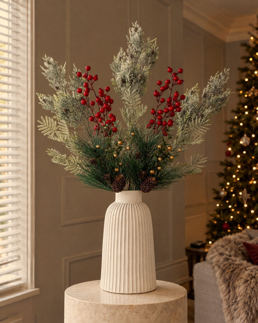 The artificial Frosted Pine & Gold Christmas Bouquet in the white ribbed Monte Large Bell Vase (With vase option) on a stone plinth in a panelled living room