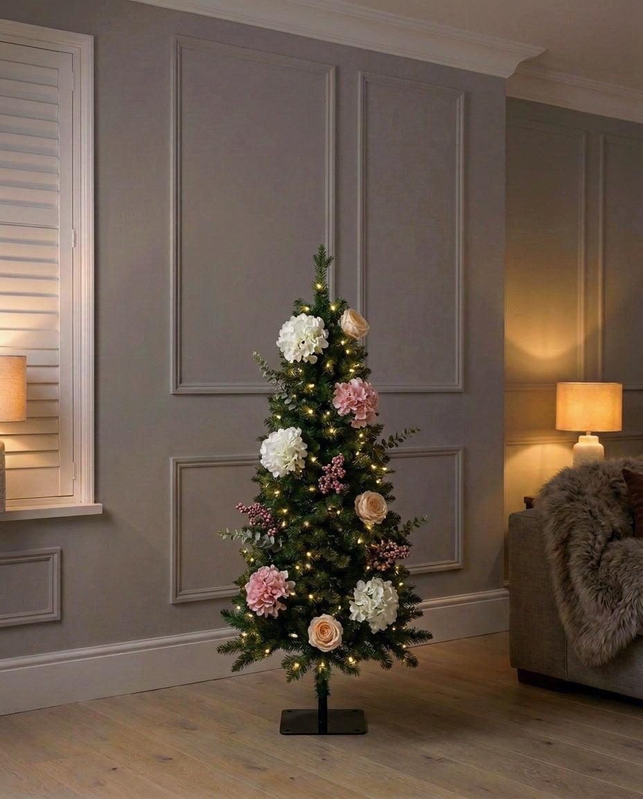 The artificial Winter Bloom Flower Christmas Tree, 120cm, lit in a panelled living room in the evening