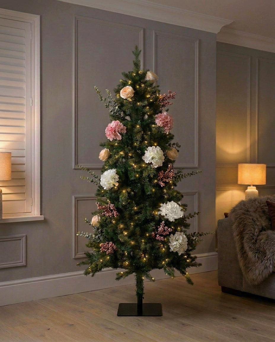 The artificial Winter Bloom Flower Christmas Tree, 180cm (6ft), lit in a panelled living room in the evening