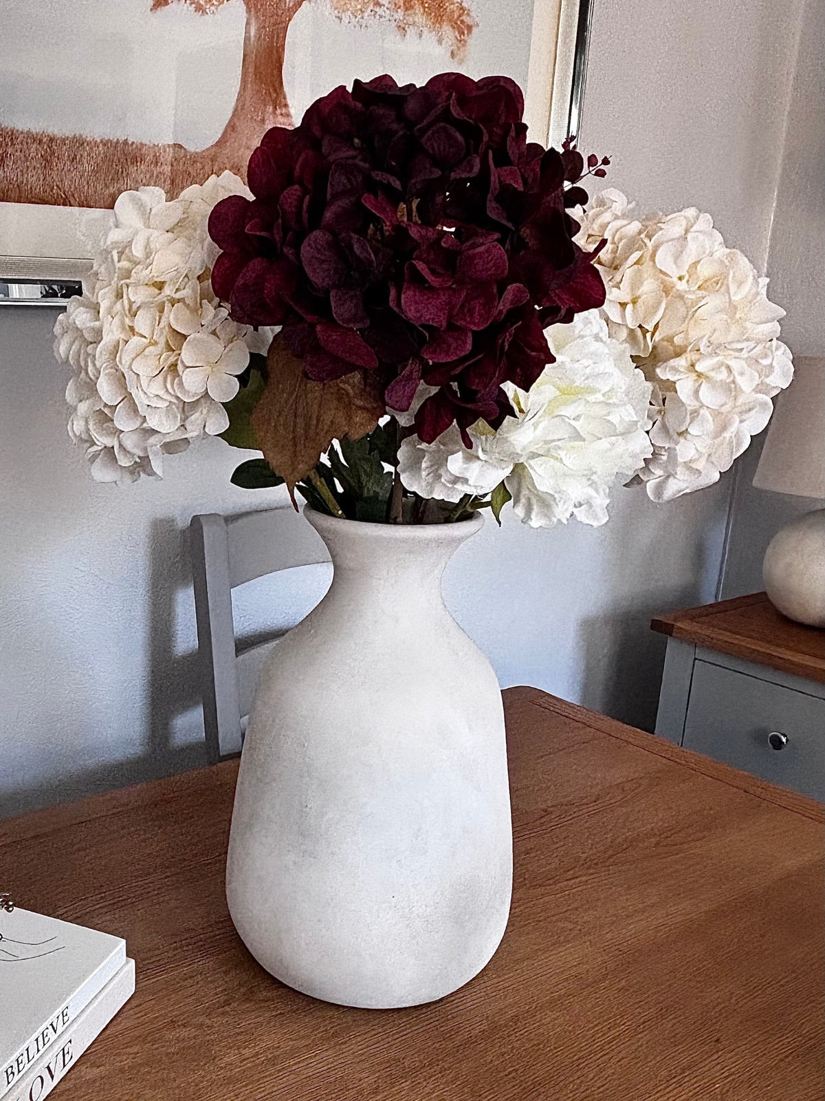 The Darcy Olpe Stone Vase on Rachael's (@ms._blooms) dining table with burgundy and cream hydrangeas. Stems sold separately