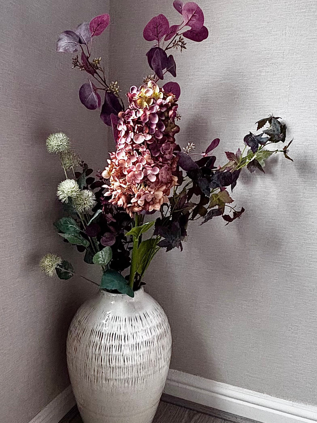 The Kemi Large Olpe Vase in Rachael's (@ms._blooms) bedroom, filled with burgundy hydrangea, thistle globes and dark foliage. Stems sold separately