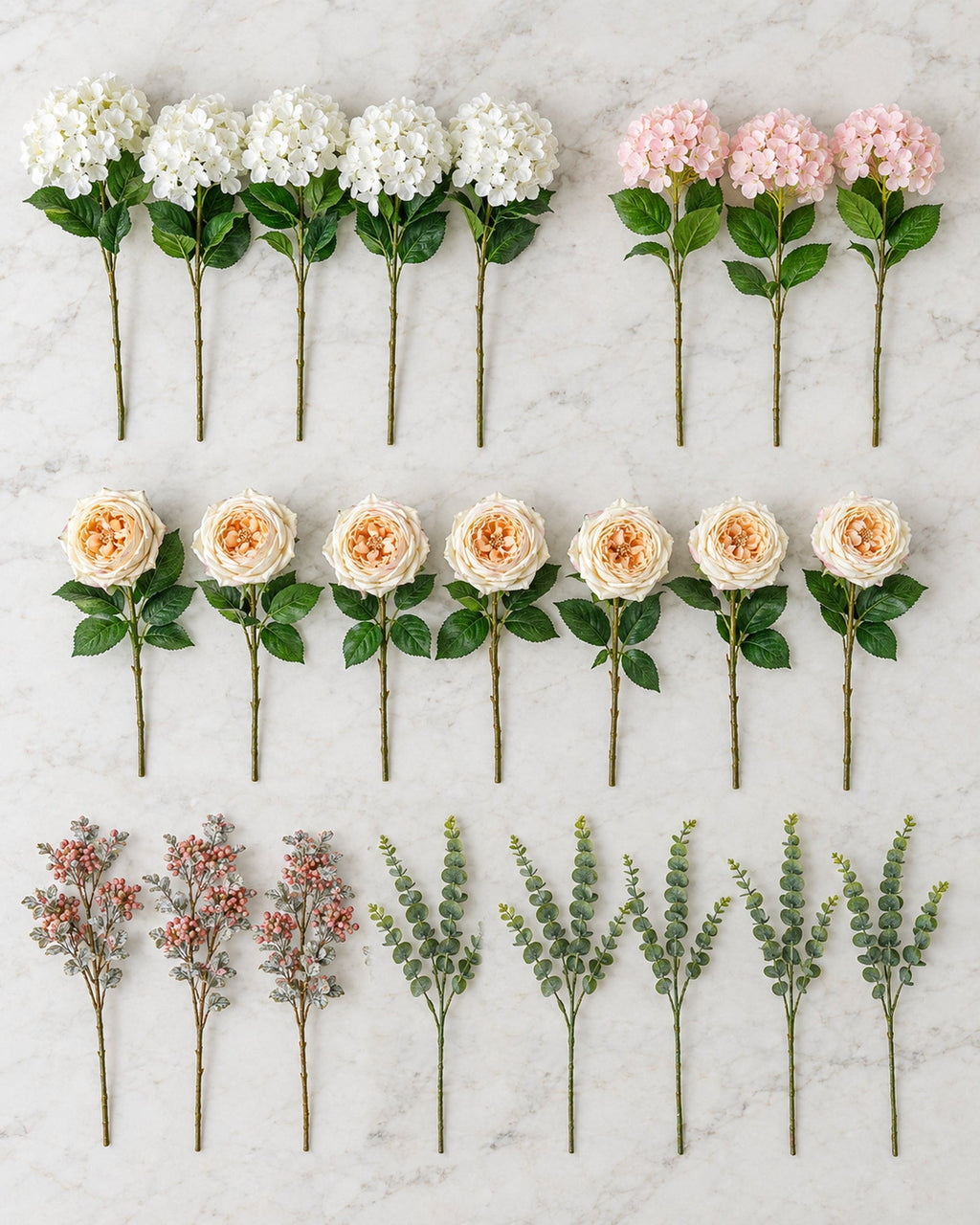 The artificial Winter Bloom flower stems for the 7ft tree laid out on a marble island