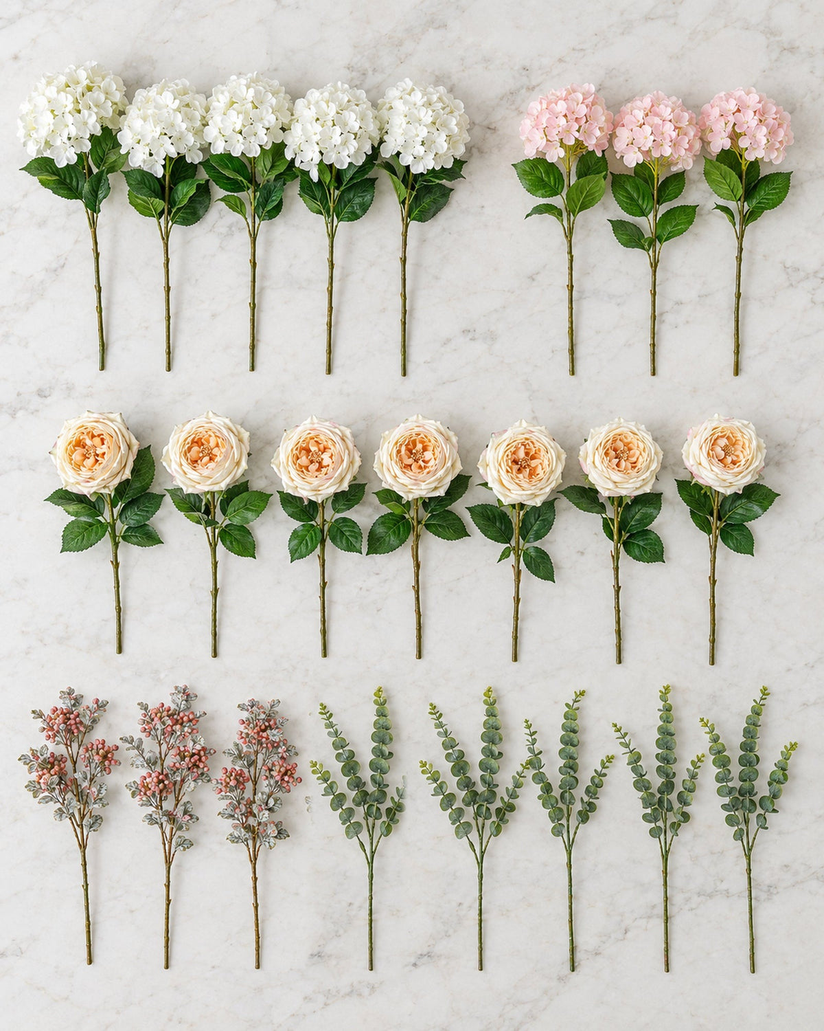 The artificial Winter Bloom flower stems for the 7ft tree laid out on a marble island