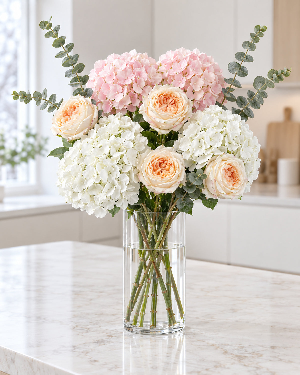 Artificial Winter Bloom flowers from the 6ft set in a plain glass vase after Christmas; vase not included